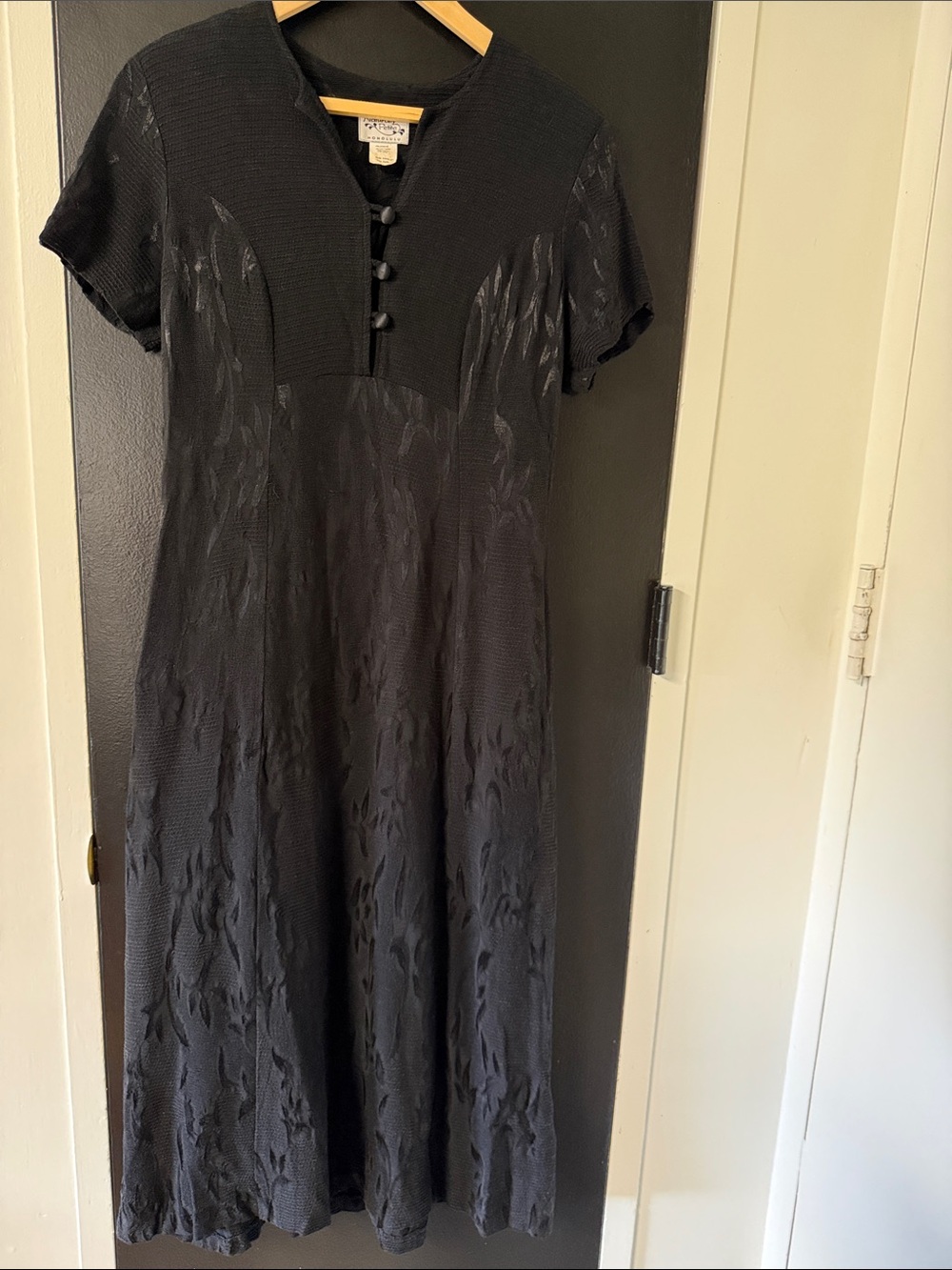Naturally Petite Honolulu dress is a black textured fabric, covered buttons.